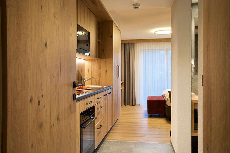 Bedroom and living area with kitchenette in Apartment C1